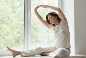 Woman practicing calm breathing and relaxation to help reduce menopause-related skin irritation 