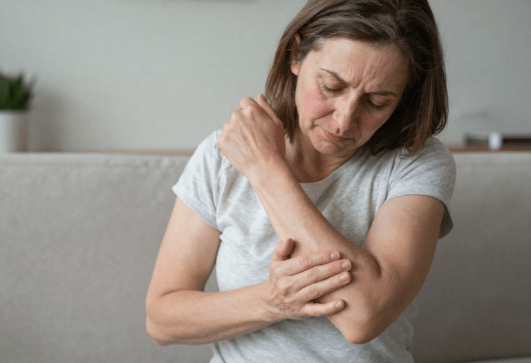 woman scratching arm due to menopause itching and dry skin