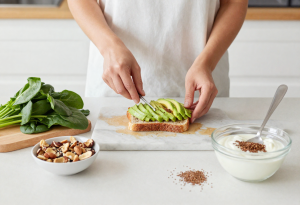 Foods to increase sex drive after menopause - Healthy foods for hormone balance including avocado, nuts, leafy greens and flaxseeds in a home kitchen