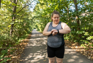 Person tracking their consistent exercise progress for long-term body transformation.