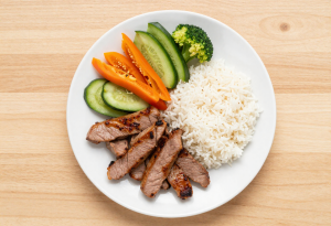 Plate of clean-eating meal with vegetables, protein, and grains