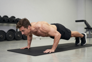 Gym person performing plank for strength training, proper form, core engagement