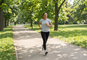 Attractive adult jogging outdoors as part of a cardio routine for sustainable weight management