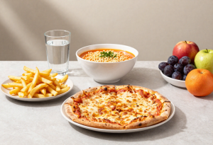 Salty meal causing bloating with pizza, fries, and ramen, paired with water and fruit to reduce puffiness