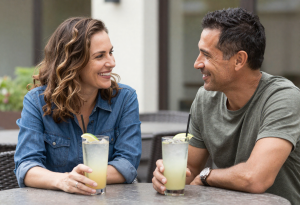 Midlife couple enjoying low-calorie drinks while having a relaxed conversation