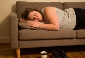 Tired adult showing signs of fatigue and stress, illustrating hormonal effects on weight retention