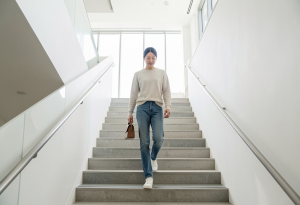 Adult taking the stairs as a simple daily micro-habit to improve health and build consistency.