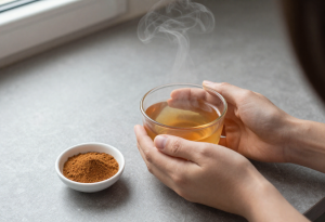Cup of cinnamon water with ground cinnamon, supporting blood sugar balance and weight management
