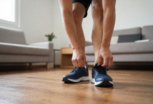 Person putting on running shoes, illustrating taking action to improve sleep quality and overall wellness