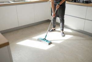 allergens in your home - Person mopping a kitchen floor to reduce indoor allergens.