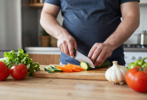 Man preparing a balanced meal in the kitchen for healthy weight management”