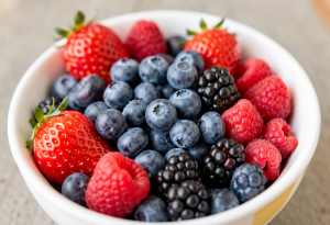 Bowl of fresh mixed berries to support anxiety reduction and mood