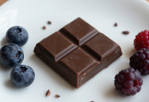 Small square of dark chocolate with cacao nibs and berries to support anxiety reduction and mood