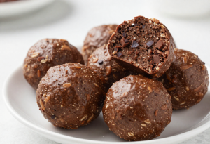 Chocolate oat energy balls in a small container, showing a rich, textured snack