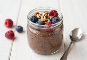 Healthy breakfast ideas - Jar of chocolate chia pudding topped with fresh berries and nuts, a creamy and nutritious whole foods breakfast