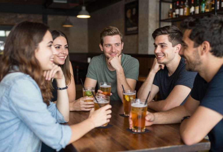 What Alcohol Does to the Liver (Signs, Damage & How to Protect It) group of people drinking alcohol at a pub social setting showing everyday alcohol consumption